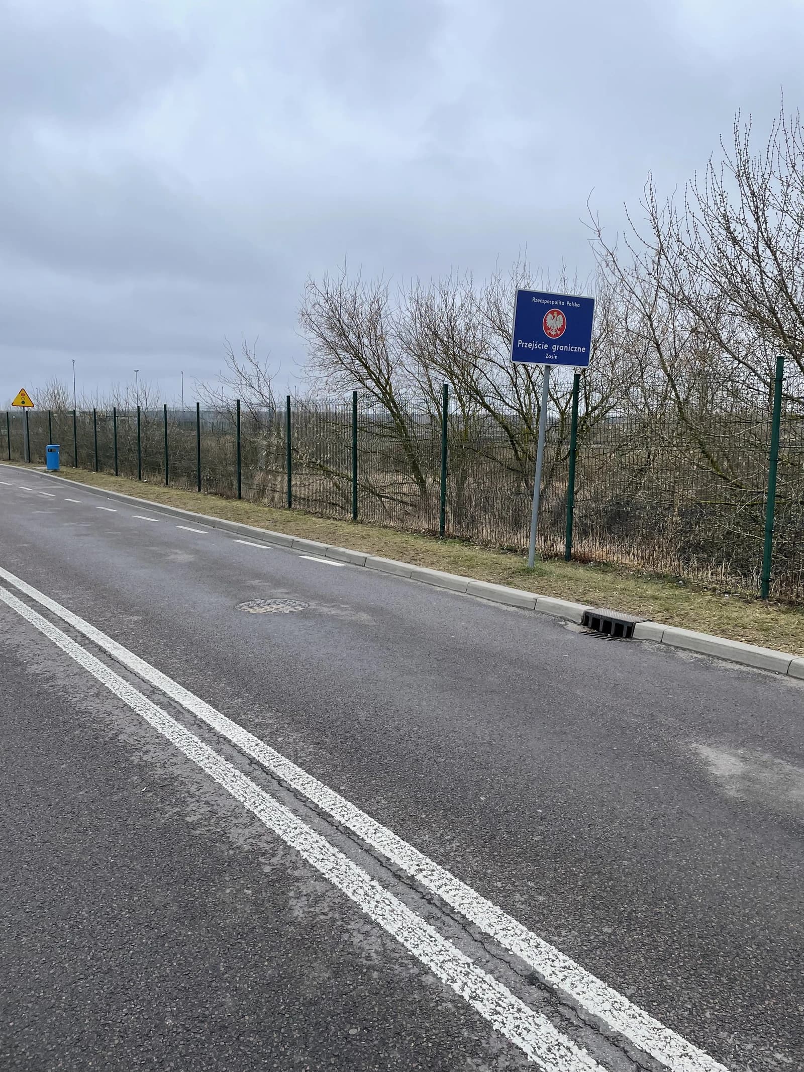 Sign for 'Przejście graniczne' (border crossing) in Poland along a road.
