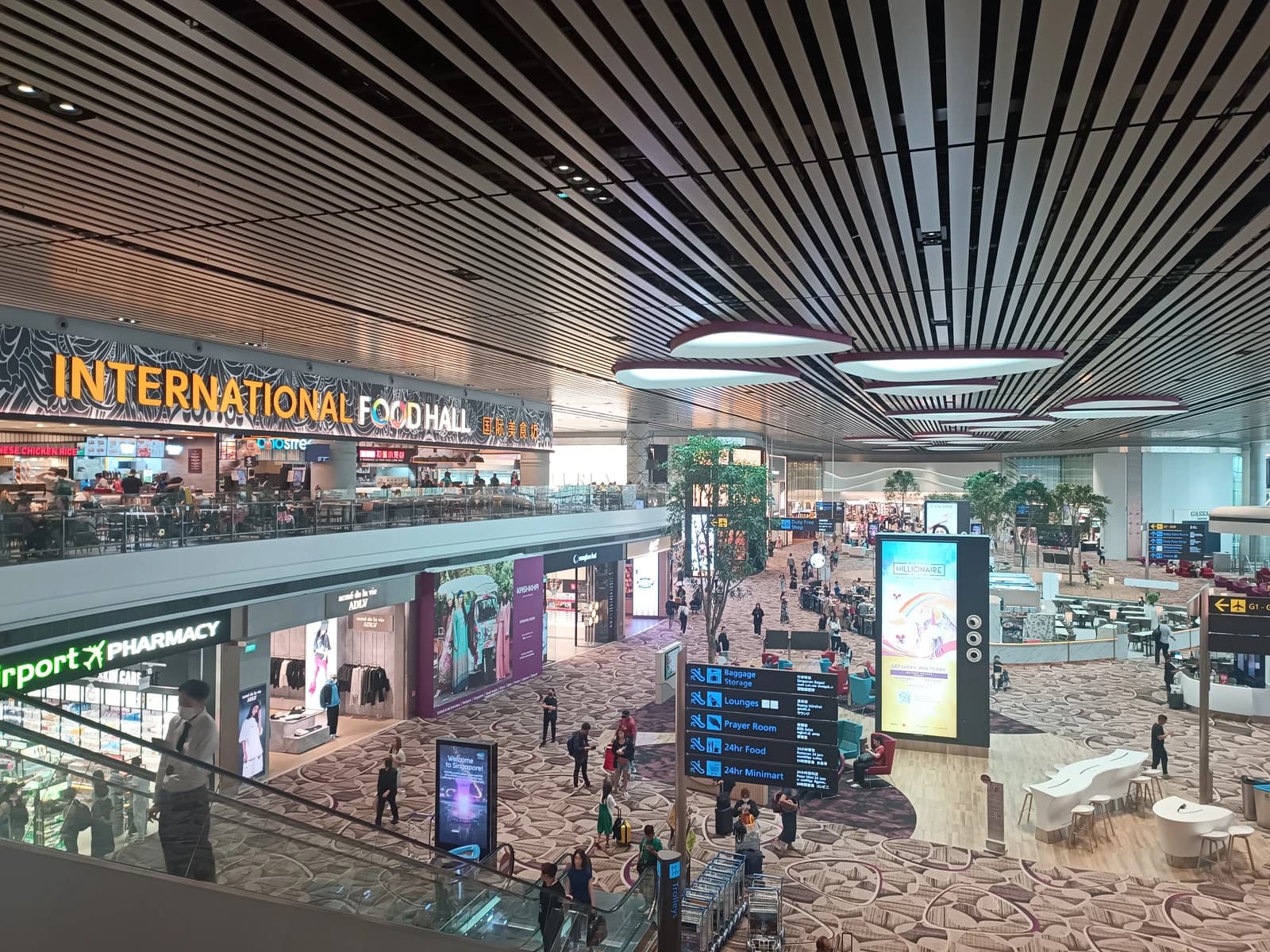 Singapore Changi Airport Terminal 4 departure hall with shopping areas and an International Food Hall.