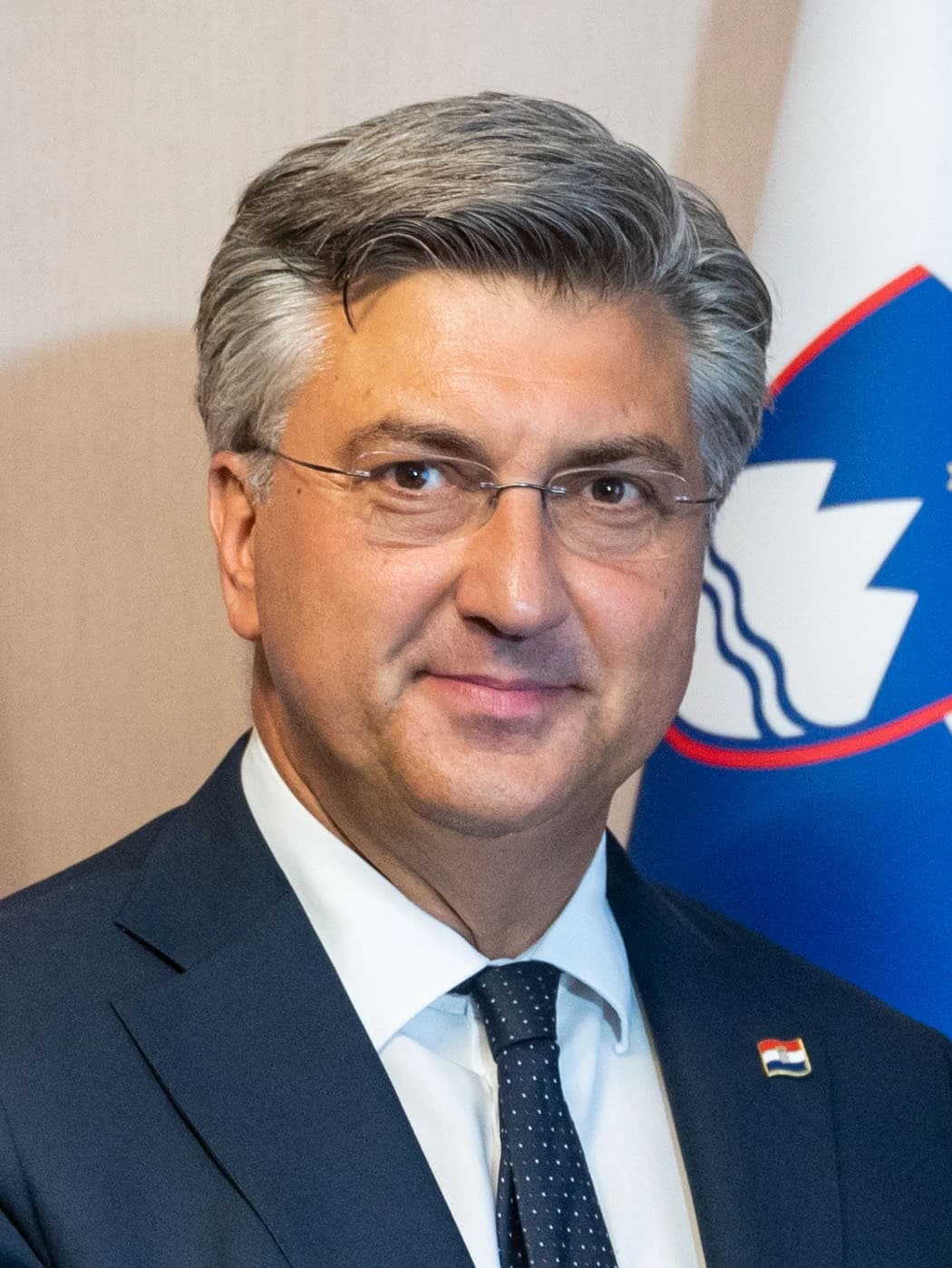 Croatian Prime Minister Andrej Plenković smiling and wearing a suit and tie.