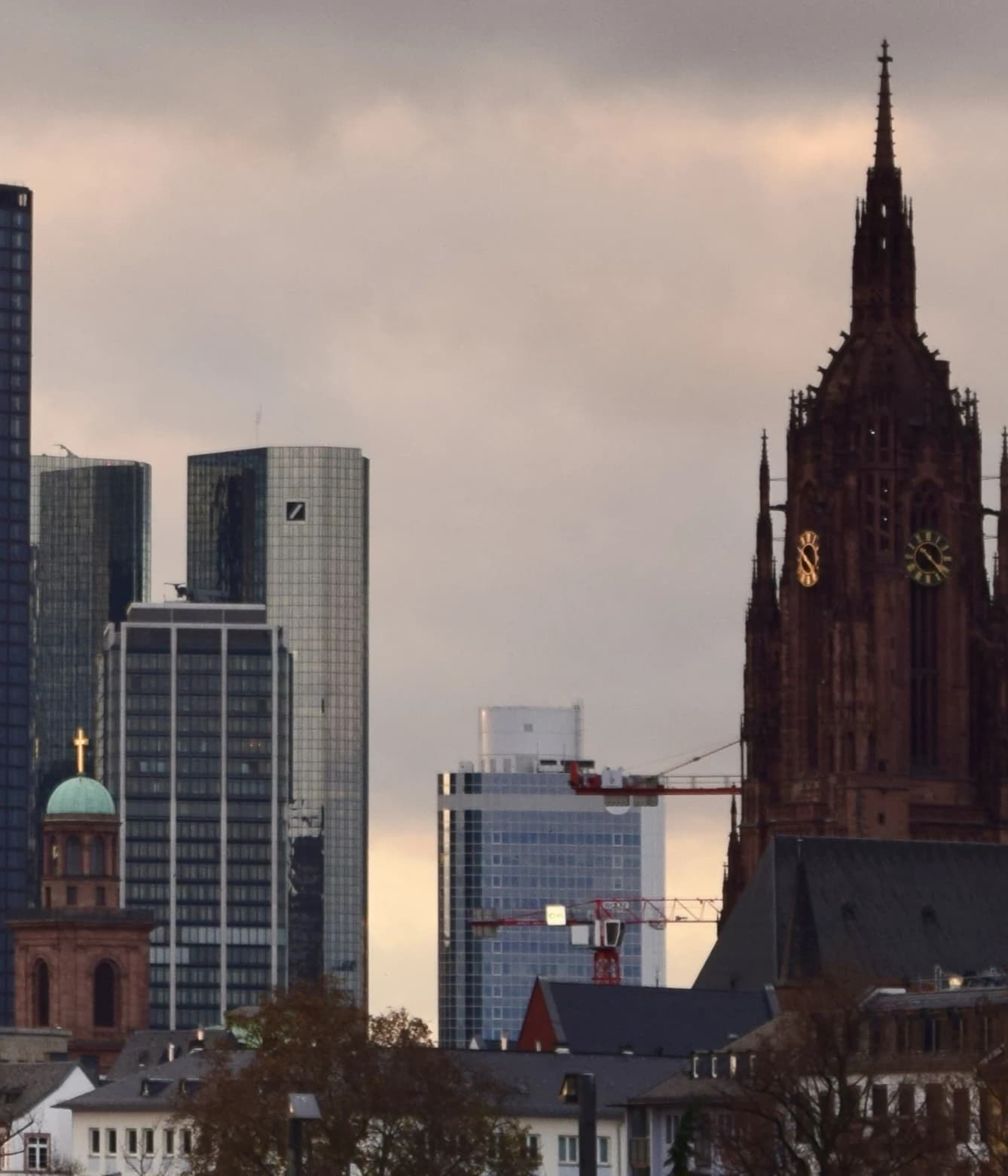 Deutsche Bank headquarters in Frankfurt am Main, Germany, under a cloudy sky.