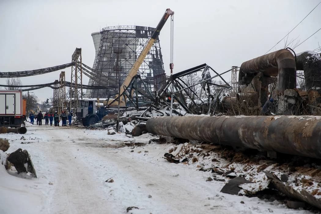 Workers survey damage at the Darnytska Combined Heat and Power Plant in Kyiv.