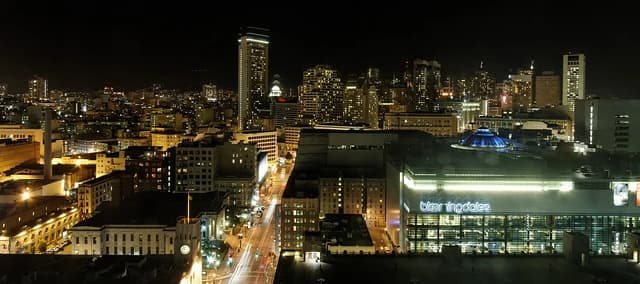San Francisco downtown skyline at night with city lights visible.