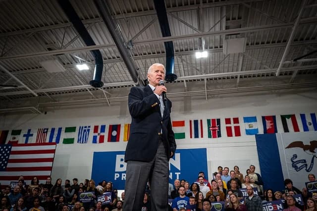 Joe Biden, Democratic presidential candidate, speaks into a microphone at a rally.