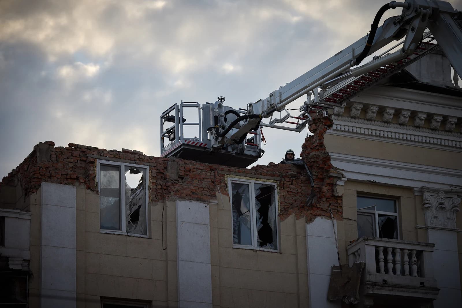 A rescuer in a cherry picker addresses damage to a building in Dnipro, Ukraine.