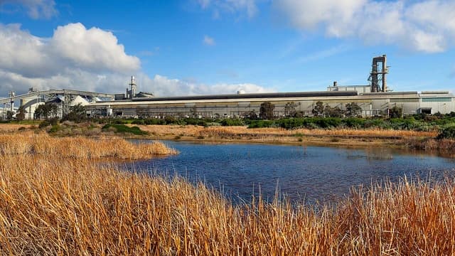 Alcoa Point Henry aluminium smelter building with industrial structures under a blue sky.