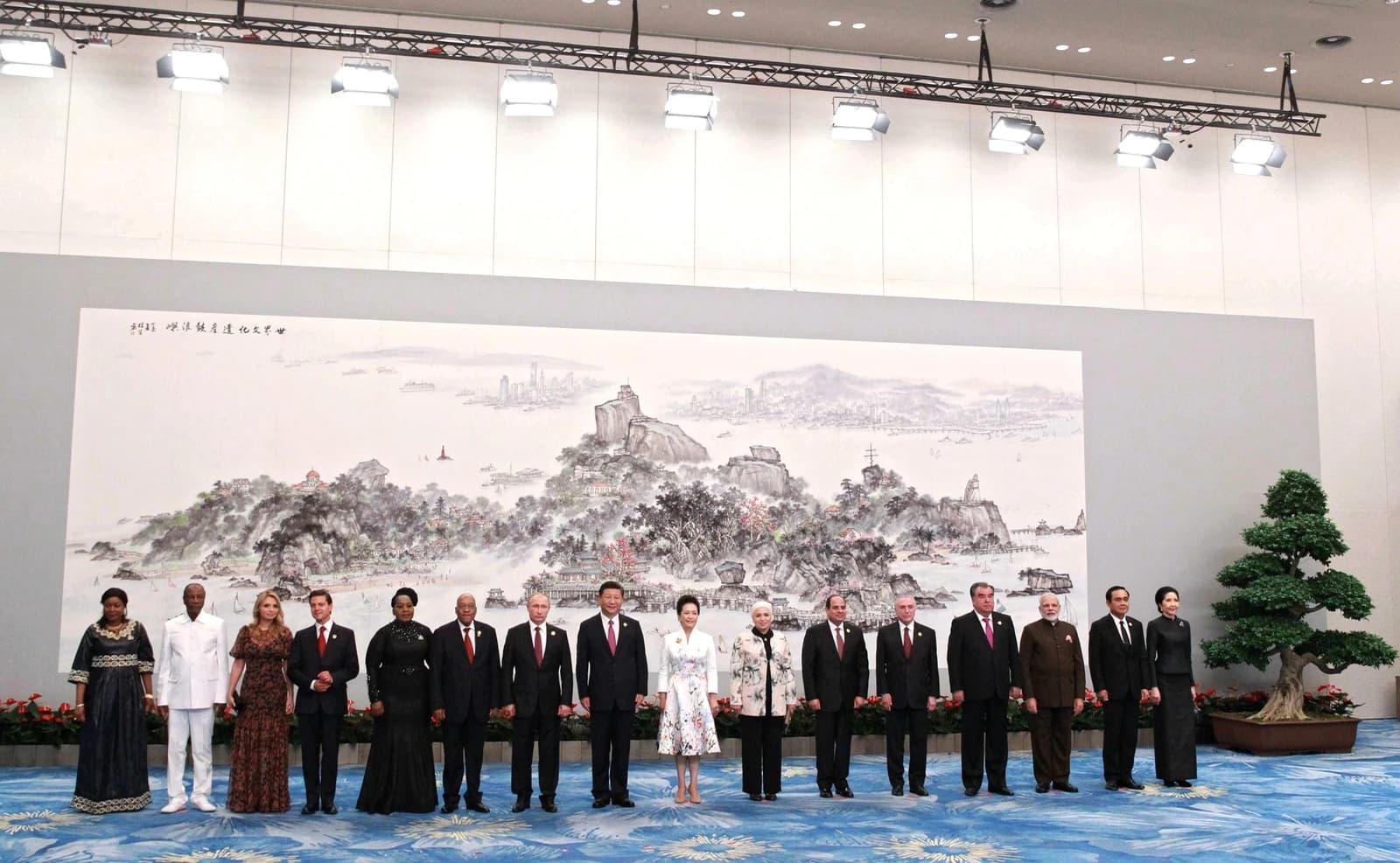 Heads of state and government stand together for a group photo.