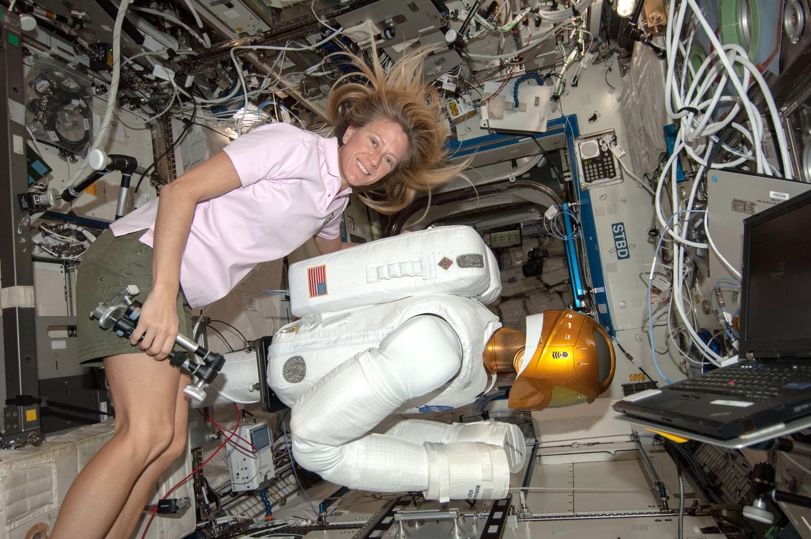 Astronaut Karen Nyberg interacts with Robonaut 2, a humanoid robot, on the International Space Station.