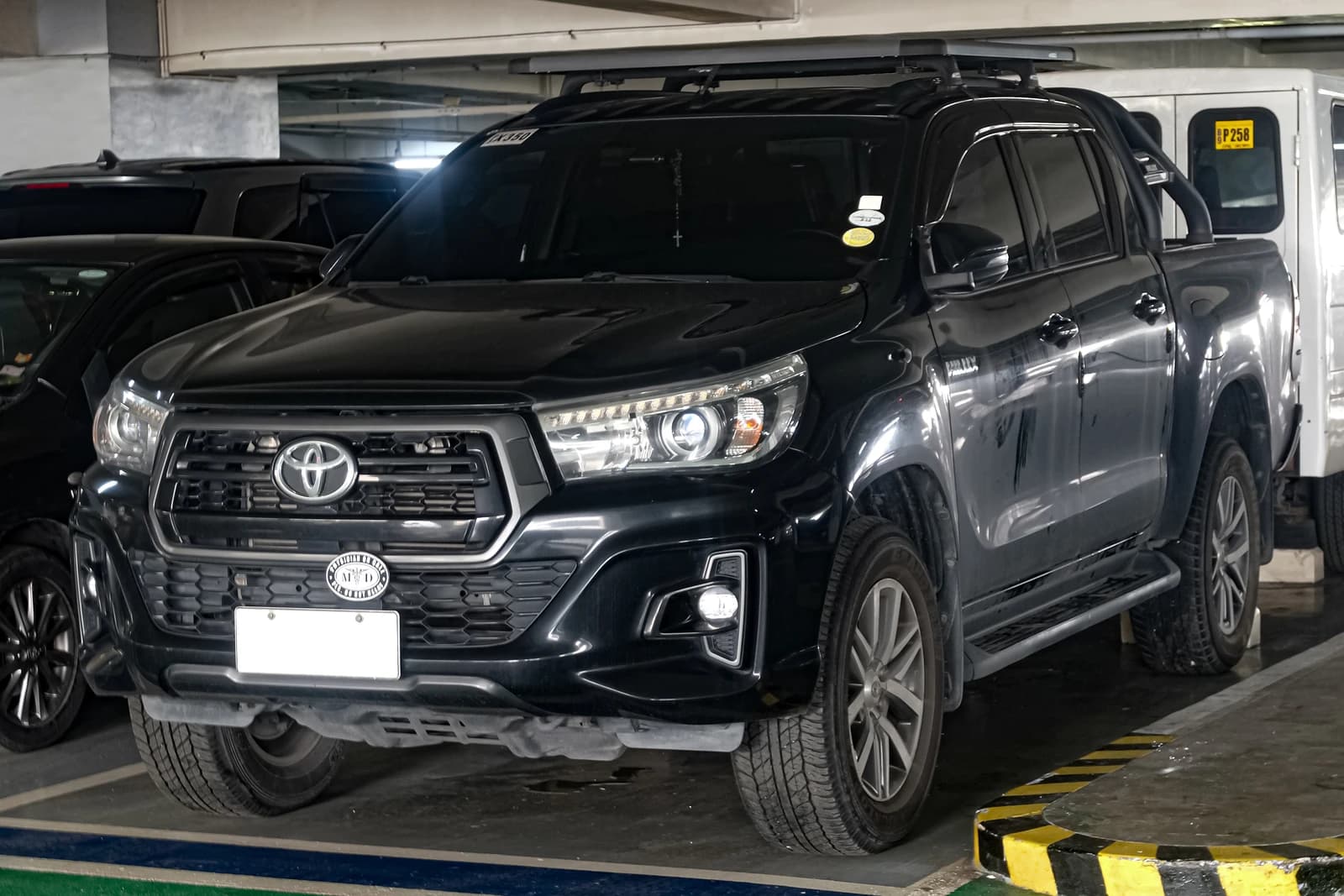 Black Toyota Hilux Conquest 4x4 pickup truck parked in an indoor garage.