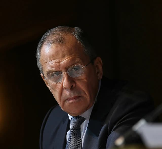 Sergey Lavrov, Russia's Foreign Minister, wearing glasses and a suit, looking forward.