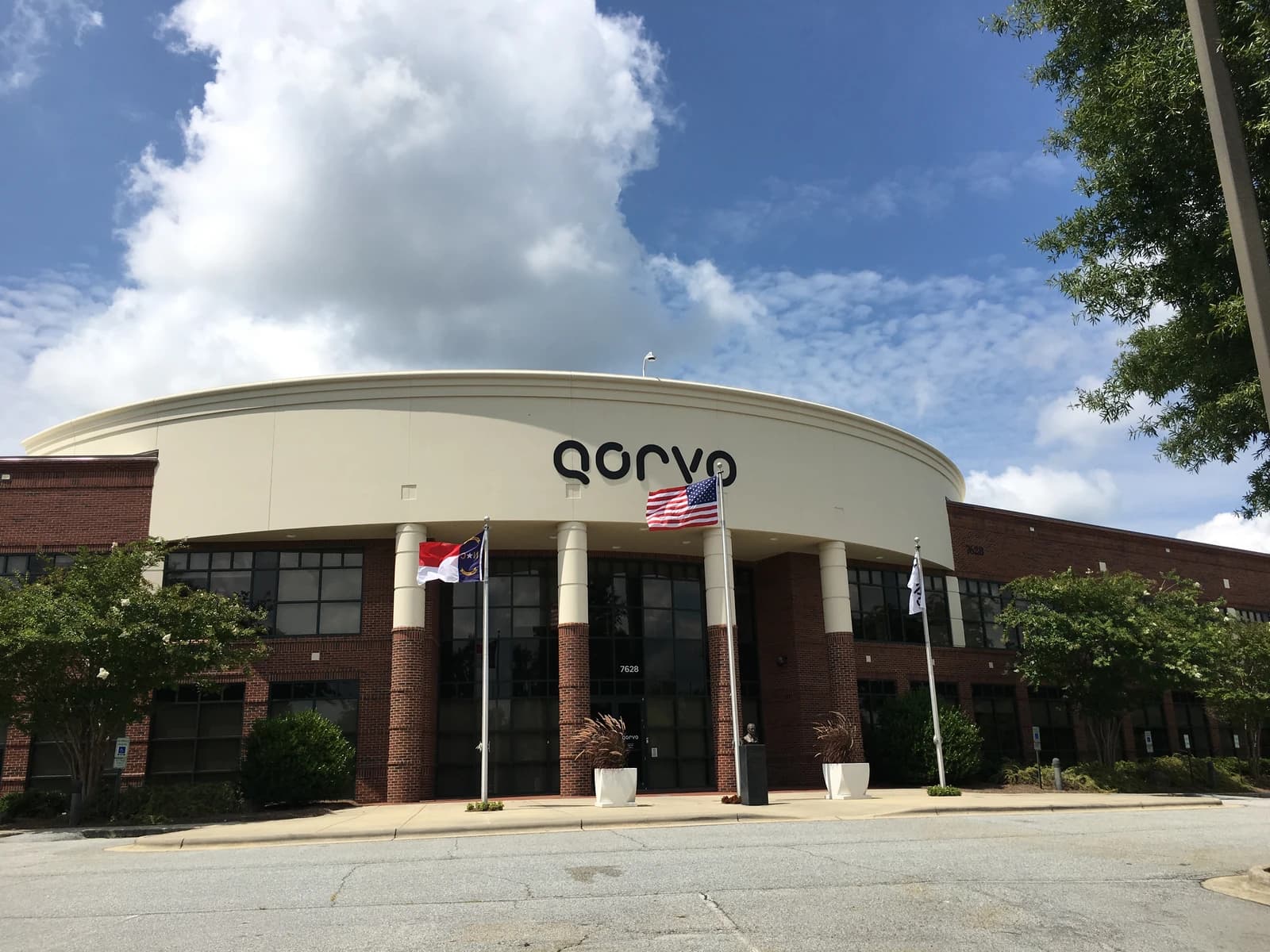 Exterior view of Qorvo building entrance with company name visible above.