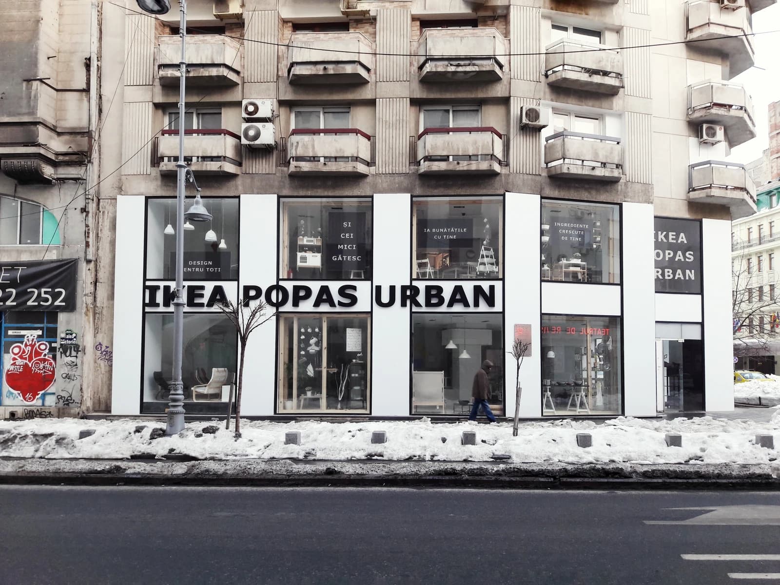 Exterior of an IKEA Popas Urban store in Bucharest, Romania, with large windows.