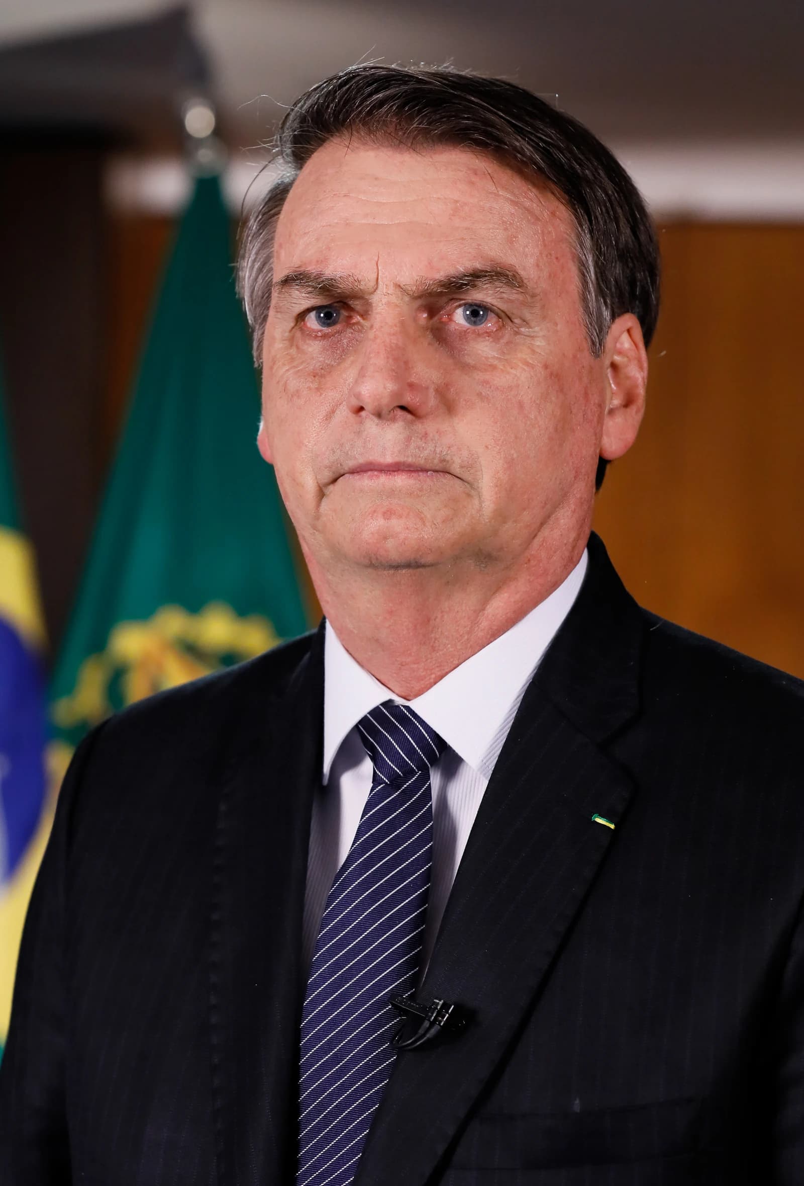 Jair Bolsonaro, former President of Brazil, looking forward in a suit and tie.