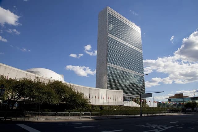 The United Nations General Assembly building and flags of member nations in New York.