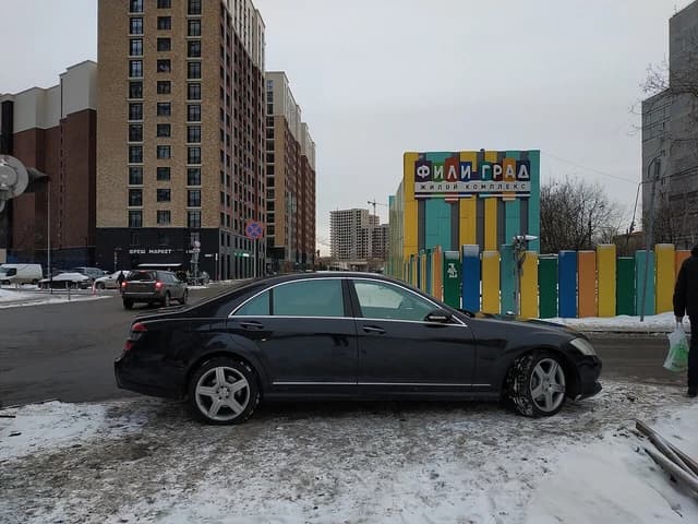 Fili-Grad residential complex in Moscow with a parked car and snowy ground.