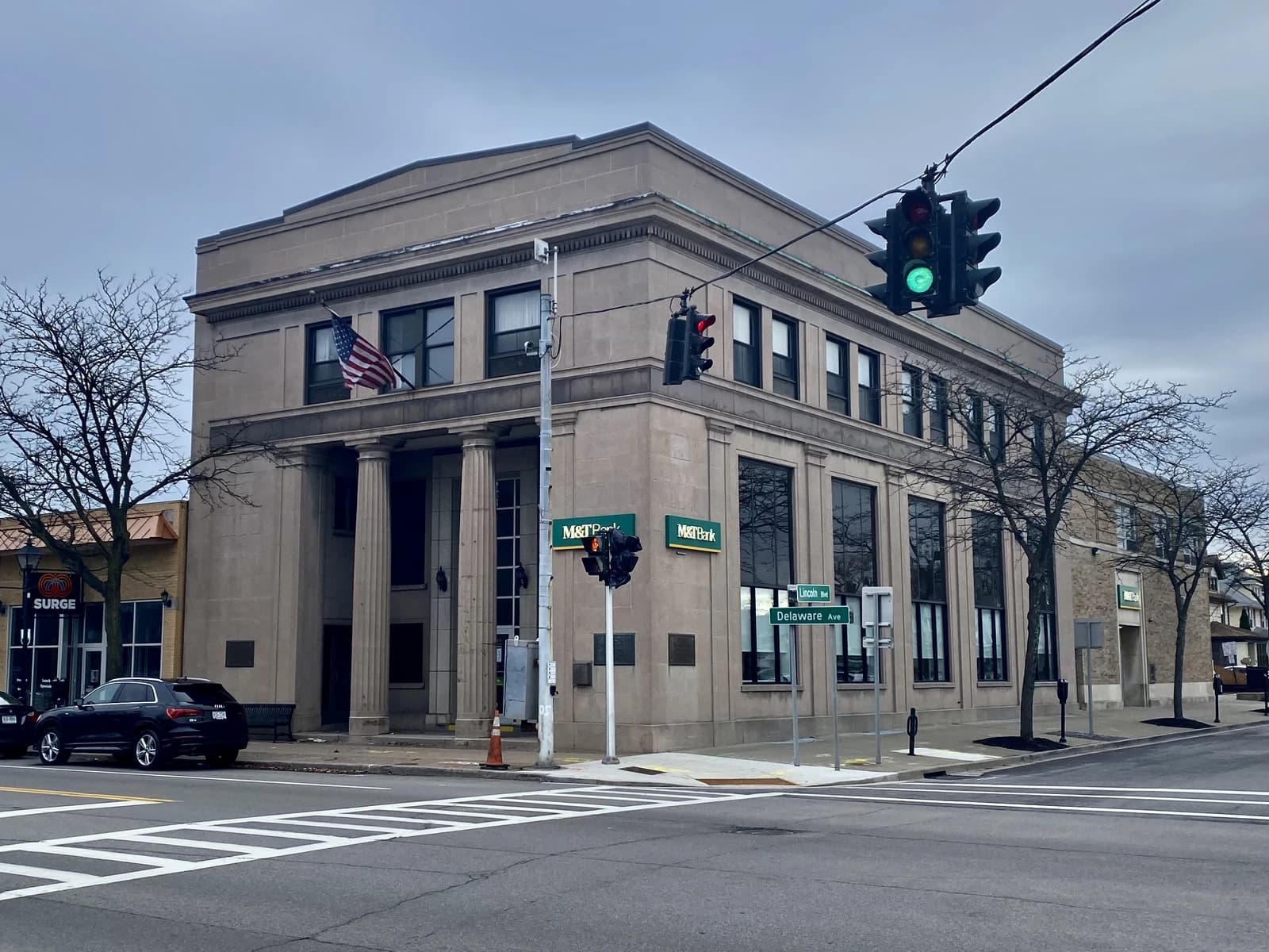 M&T Bank Kenmore Branch building with an American flag and street signs.
