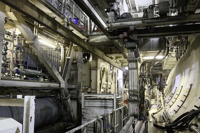 Interior of a large tunnel boring machine showing complex machinery and structures.