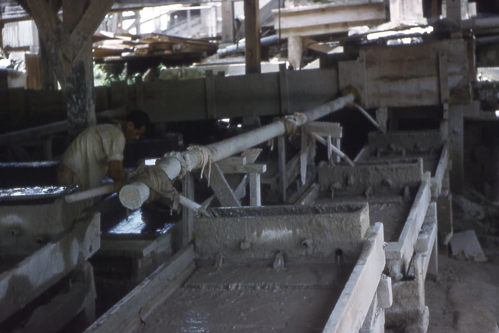 Man operates machinery in an ore processing facility.