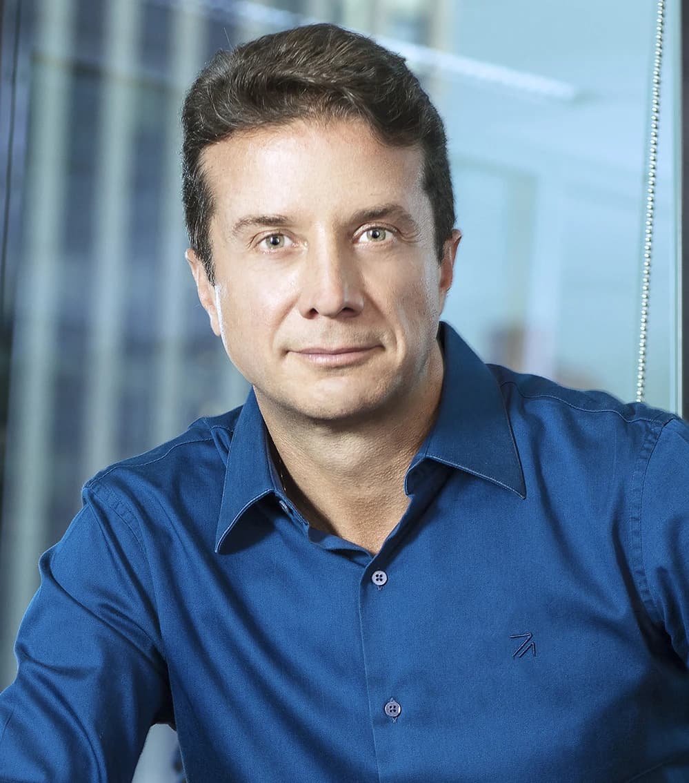 Ronaldo Pereira Junior, CEO, seated and looking forward in a professional setting.