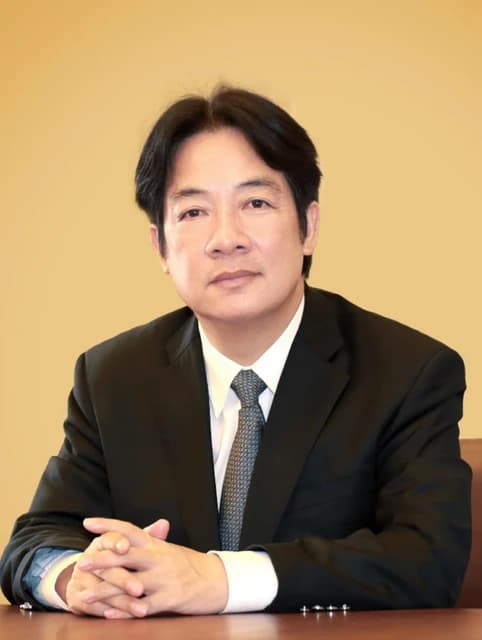 Lai Ching-te, Taiwan's Vice President, sits at a wooden table.
