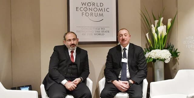 Ilham Aliyev, President of Azerbaijan, and Nikol Pashinyan, Prime Minister of Armenia, sitting side-by-side.