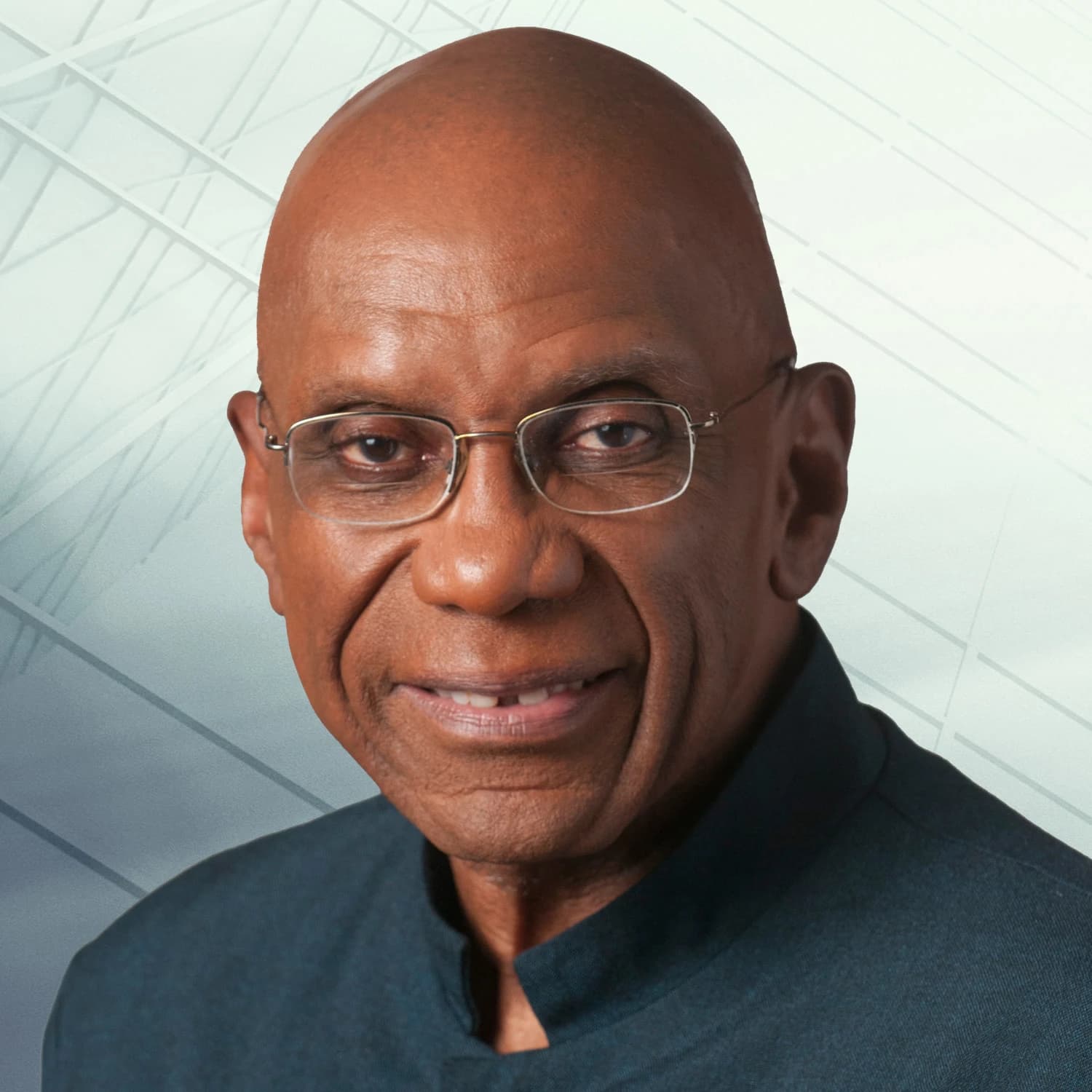 R. DeLisle Worrell, former Governor of the Central Bank of Barbados, smiles at the camera.