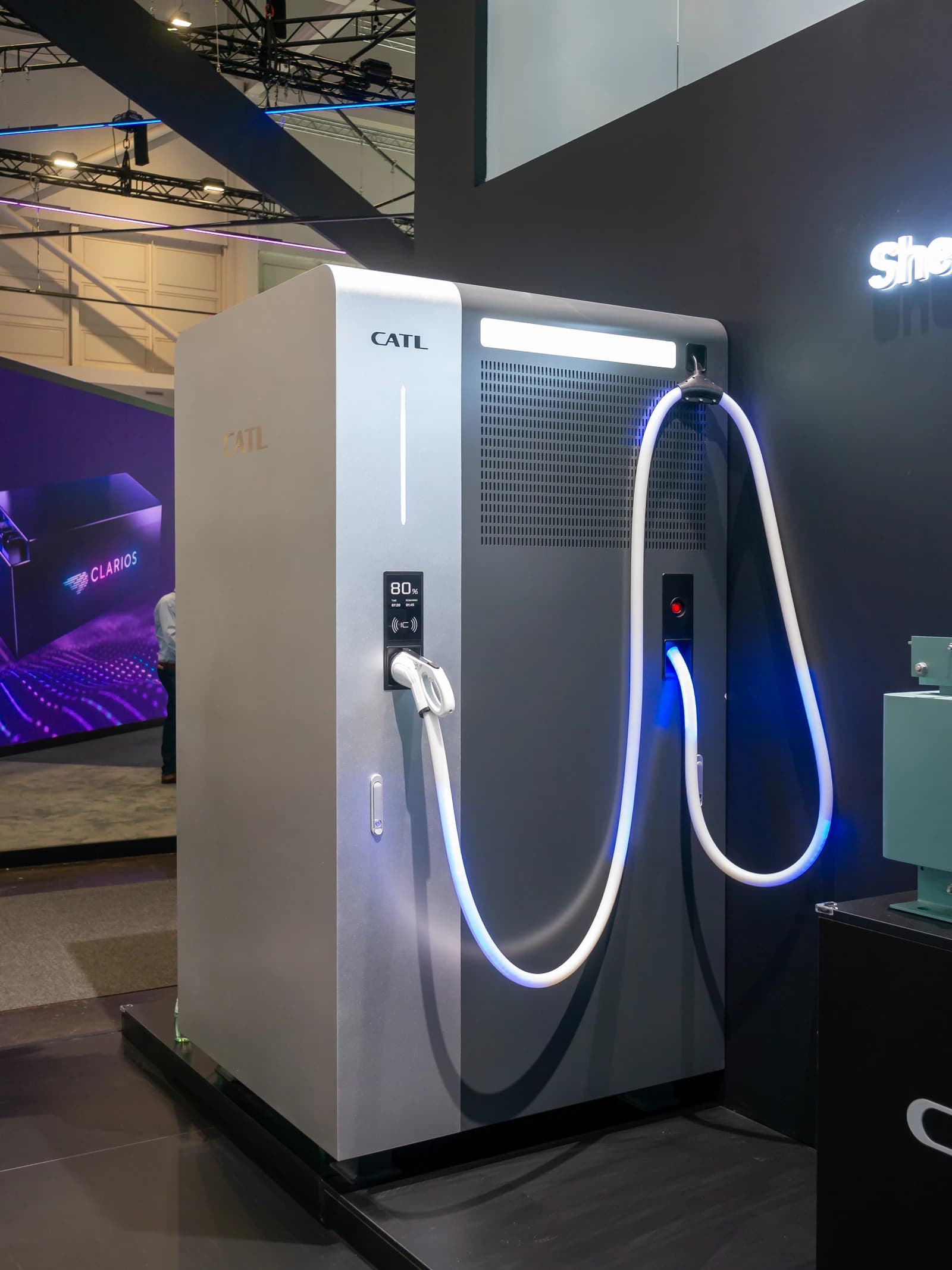 CATL electric vehicle charging station with glowing blue cables at an exhibition.