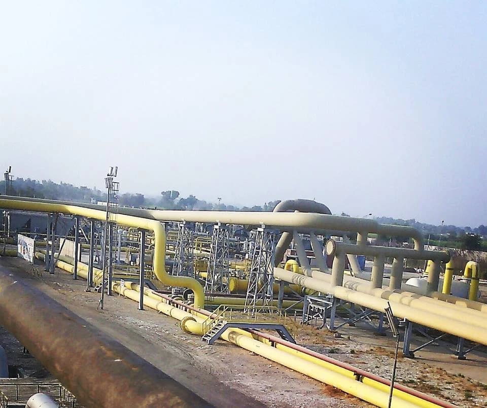 Pipelines and industrial equipment at the Qadirpur Gas Field facility.