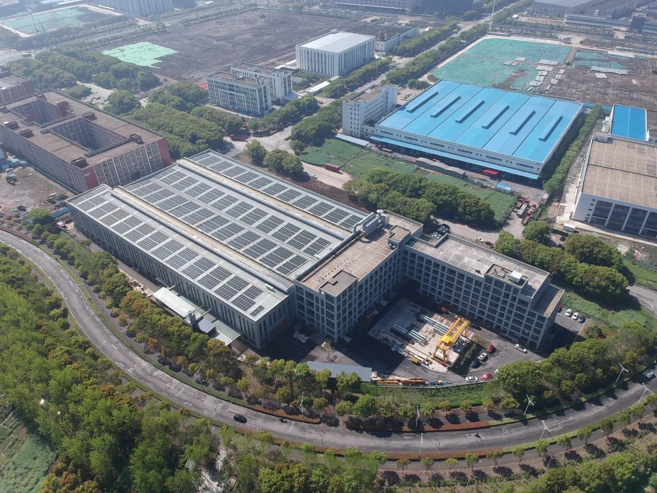 Aerial view of an industrial complex with various factory buildings and surrounding roads.
