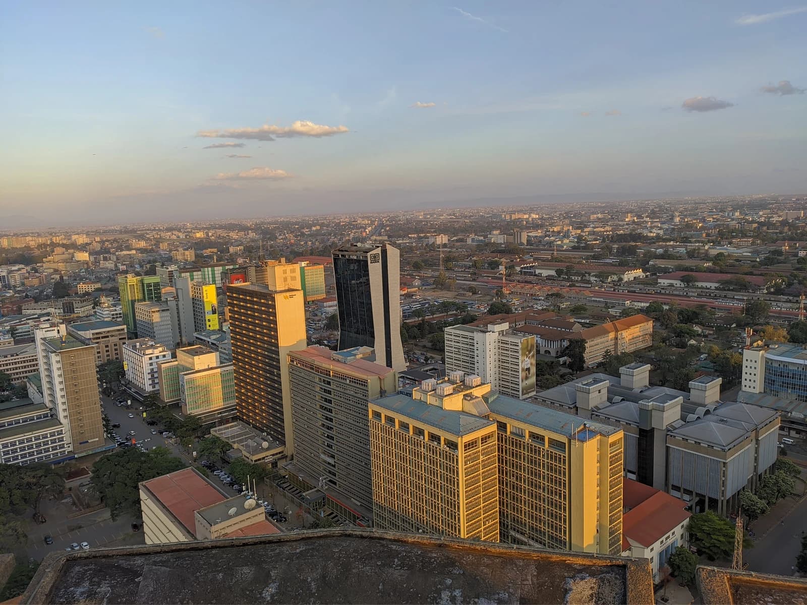 Aerial view of the Nairobi skyline from the KICC rooftop at golden hour.
