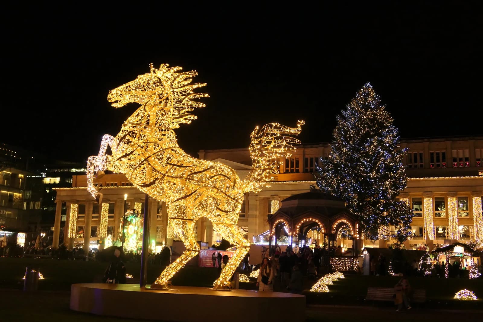 An illuminated horse sculpture stands at a Christmas market in the Black Forest.