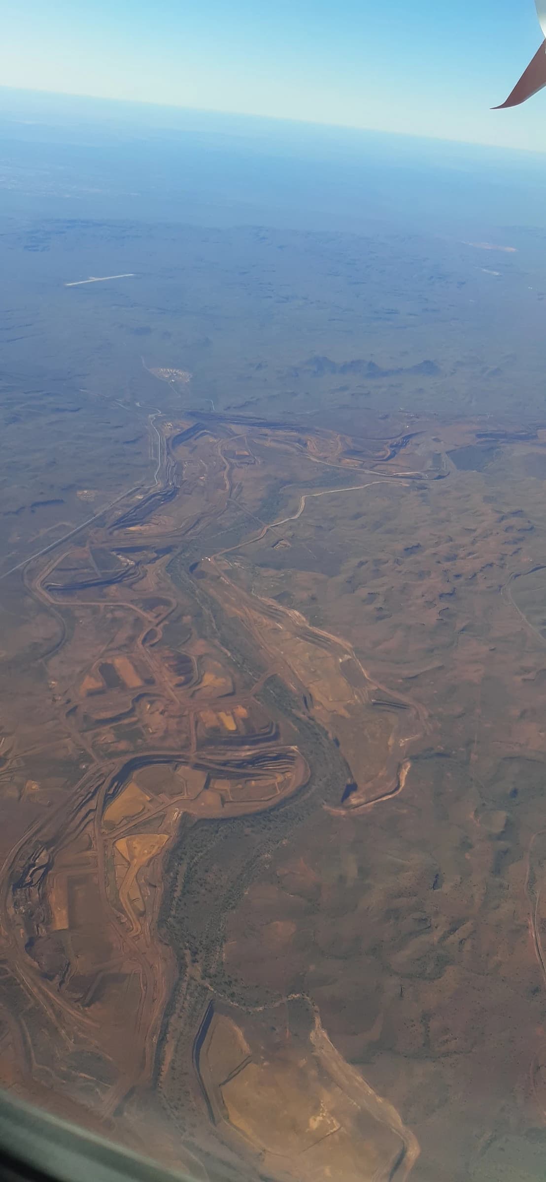 Aerial view shows the expansive open-pit operations of the BHP Yandi iron ore mine.