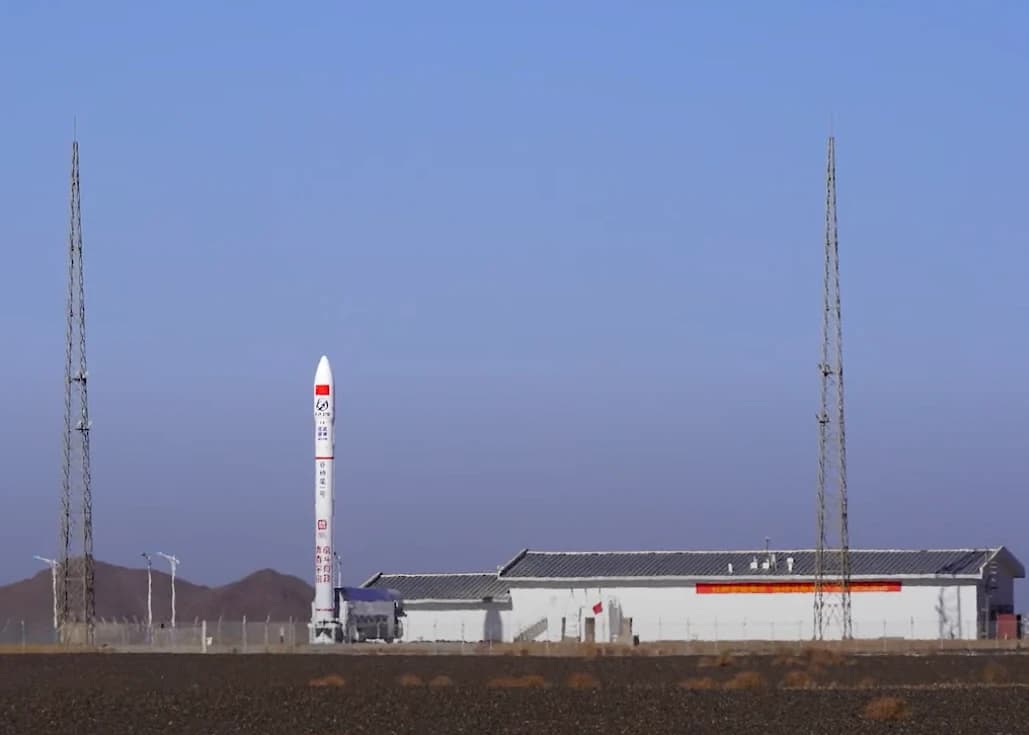 Ceres-1 Yao-4 carrier rocket standing vertically on a launchpad under a clear sky.