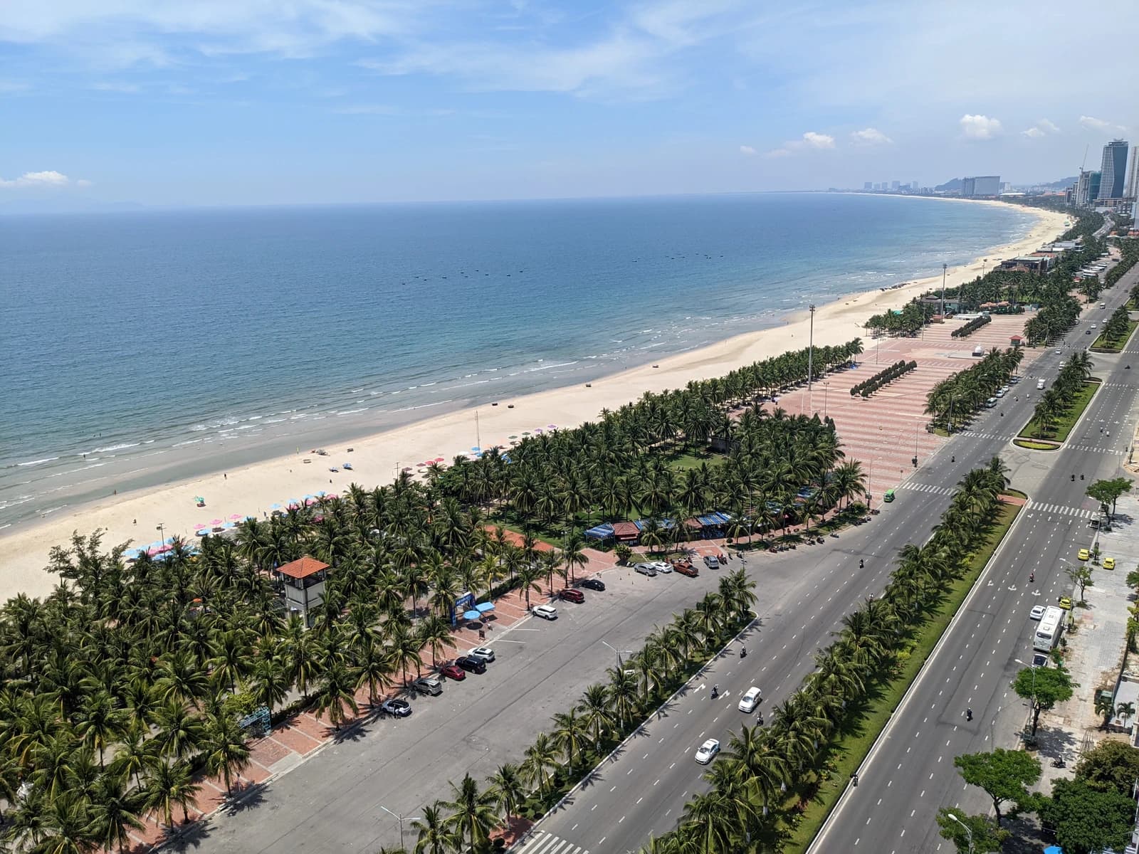 Aerial view of My Khe Beach coastline and city buildings in Da Nang, Vietnam.