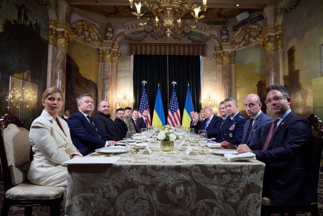 President Volodymyr Zelenskyy and various Ukrainian and US officials at a long table.