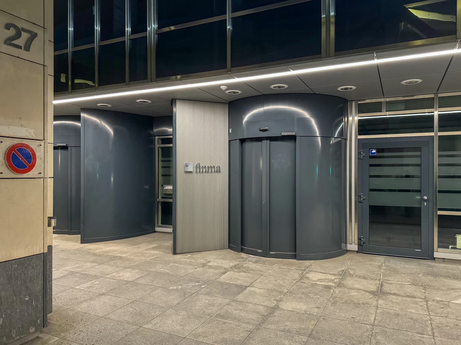Entrance of the Finma building with "finma" logo visible on the wall.