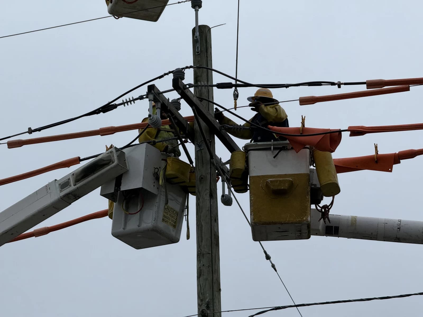 Public Service, Electric and Gas company lineworkers repairing a utility pole in Ewing Township.