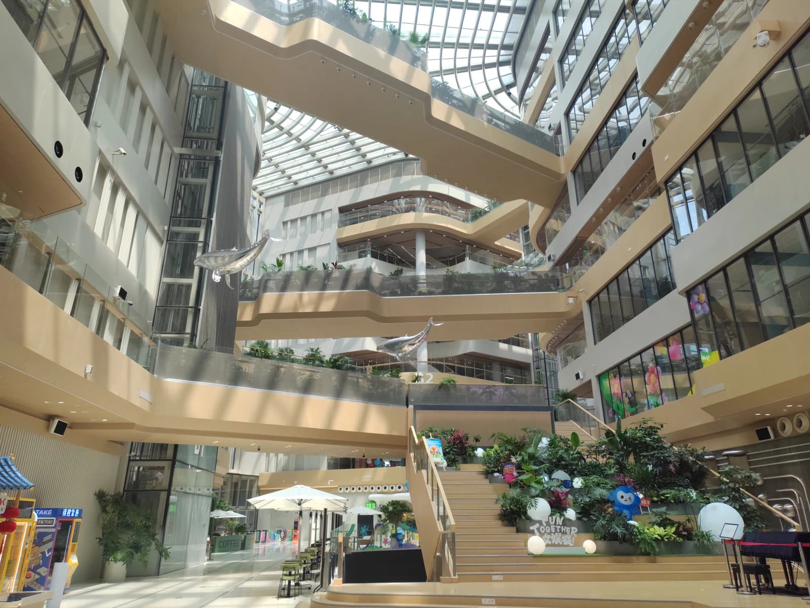 Interior of Alibaba Chaoyang Technology Park with multiple levels and glass roof.