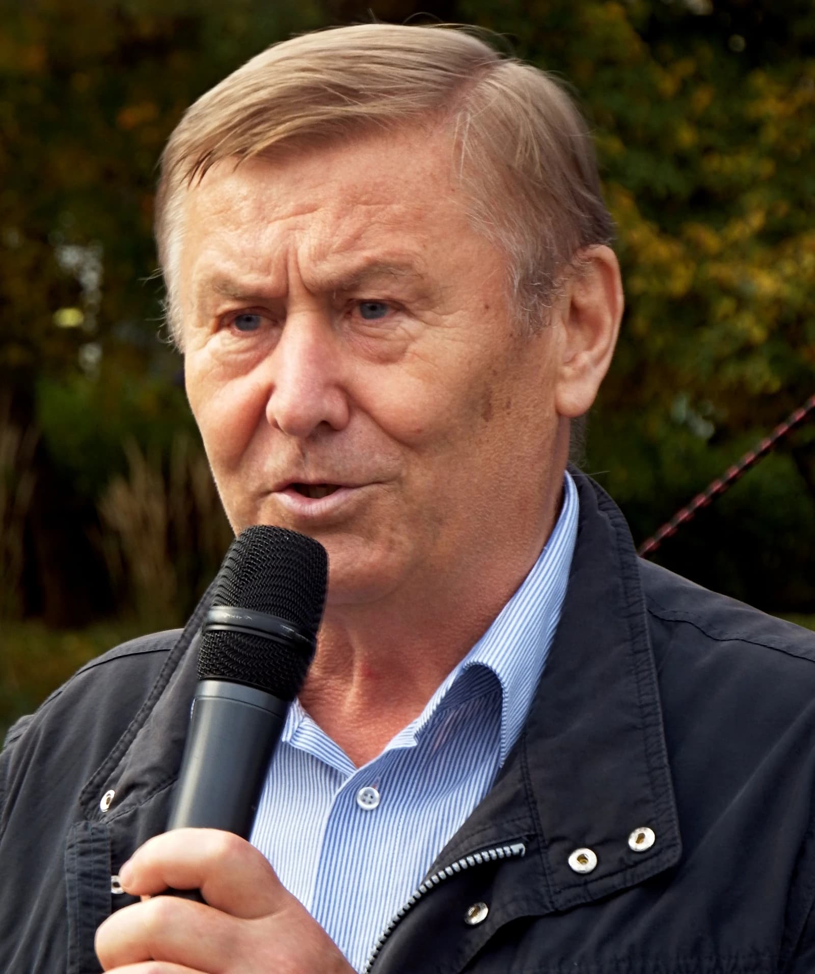 Miroslav Grebeníček, Czech Communist leader, speaking into a microphone.