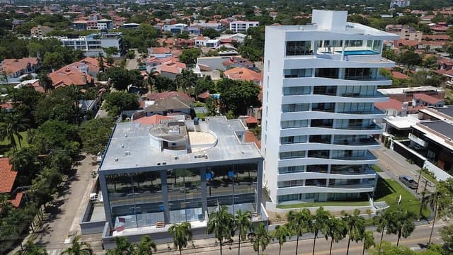 Aerial view of modern white residential building and other structures in Las Palmas, Santa Cruz.