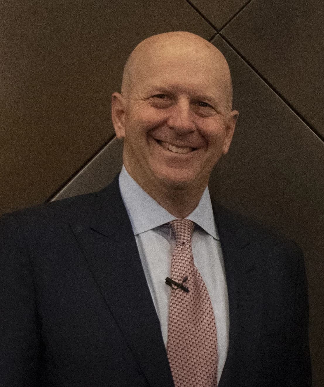 David Solomon, CEO of Goldman Sachs, smiling and wearing a suit and tie.
