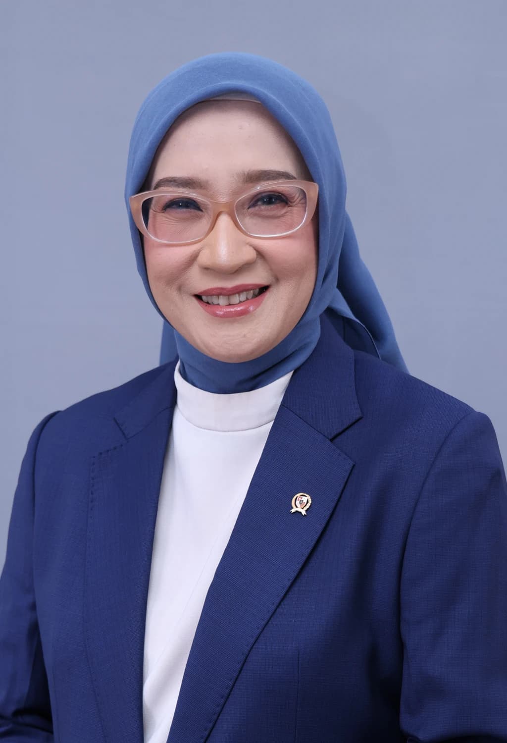 Rini Widyantini, Minister of PAN-RB, smiles in a professional headshot.