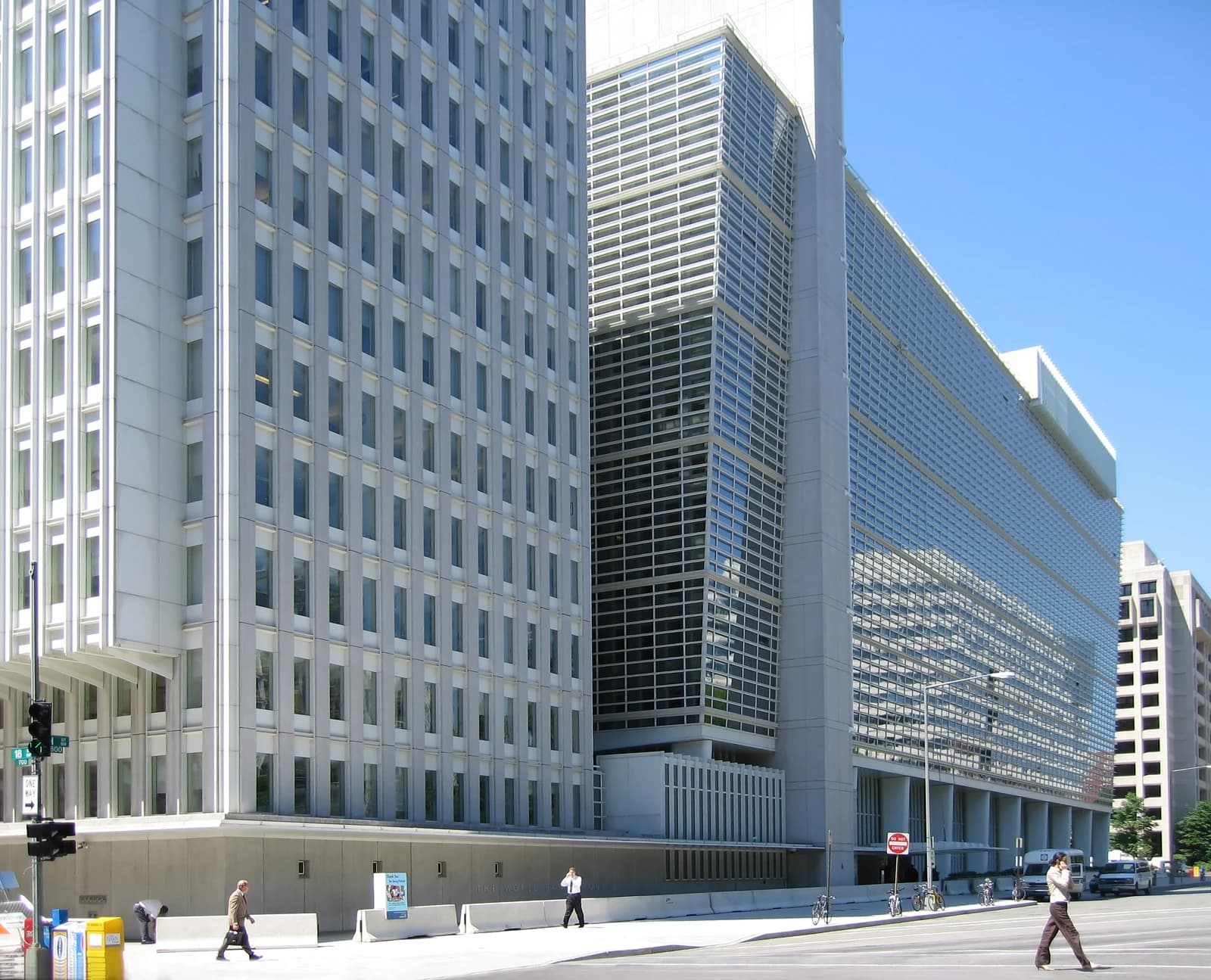 World Bank building exterior in Washington D.C., with people walking on the sidewalk.