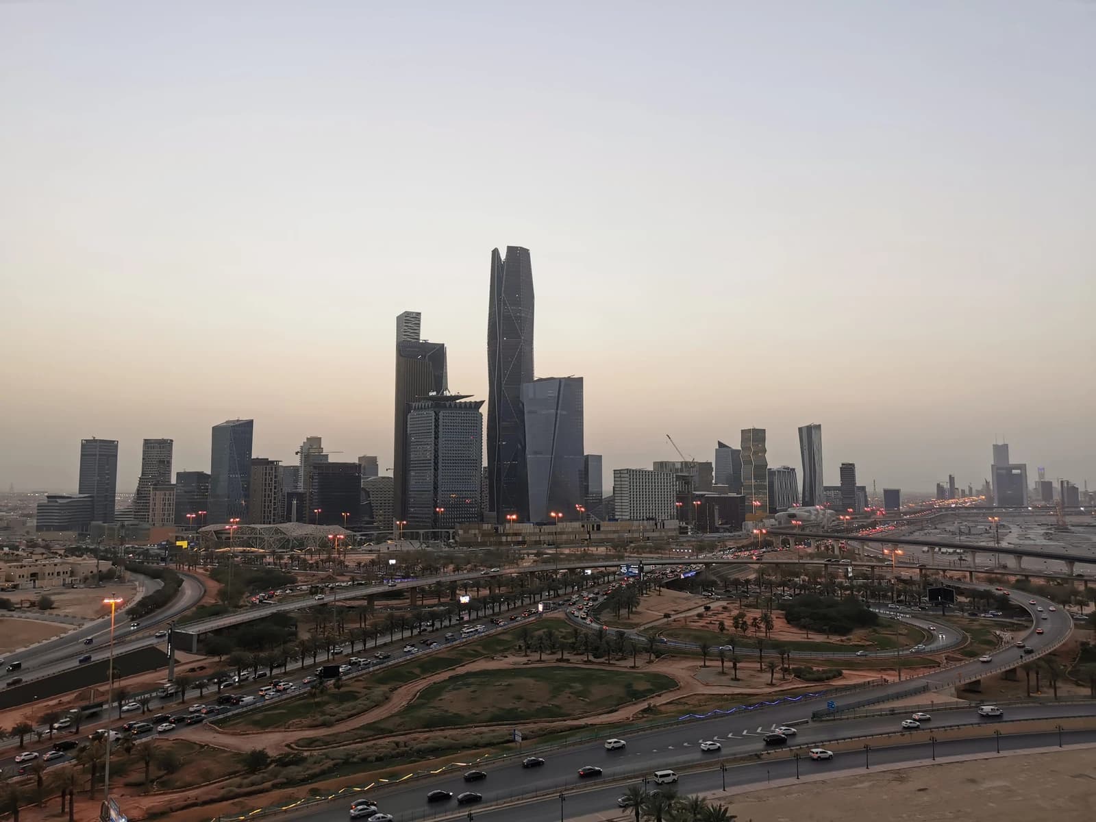King Abdullah Financial District skyline with highways and cars in the foreground.
