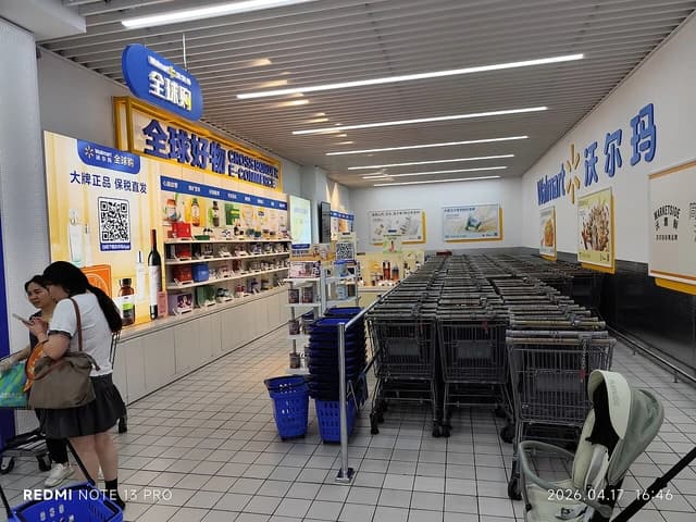 Walmart supermarket interior in Heyuan, China, with shopping carts and display shelves.