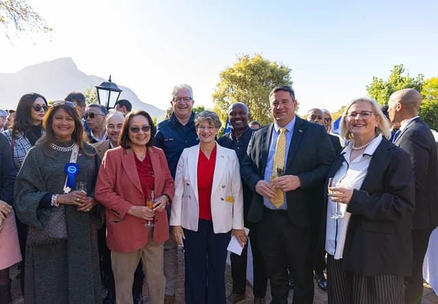 South African government officials, including several women and men, standing outdoors in a group.