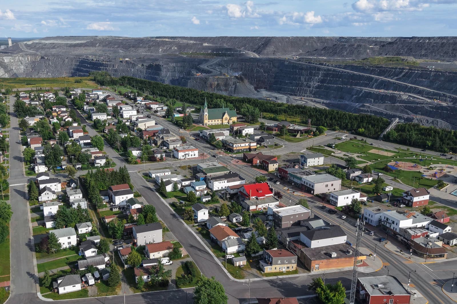 Aerial view of the town of Malartic, Quebec, next to a large open-pit mine.