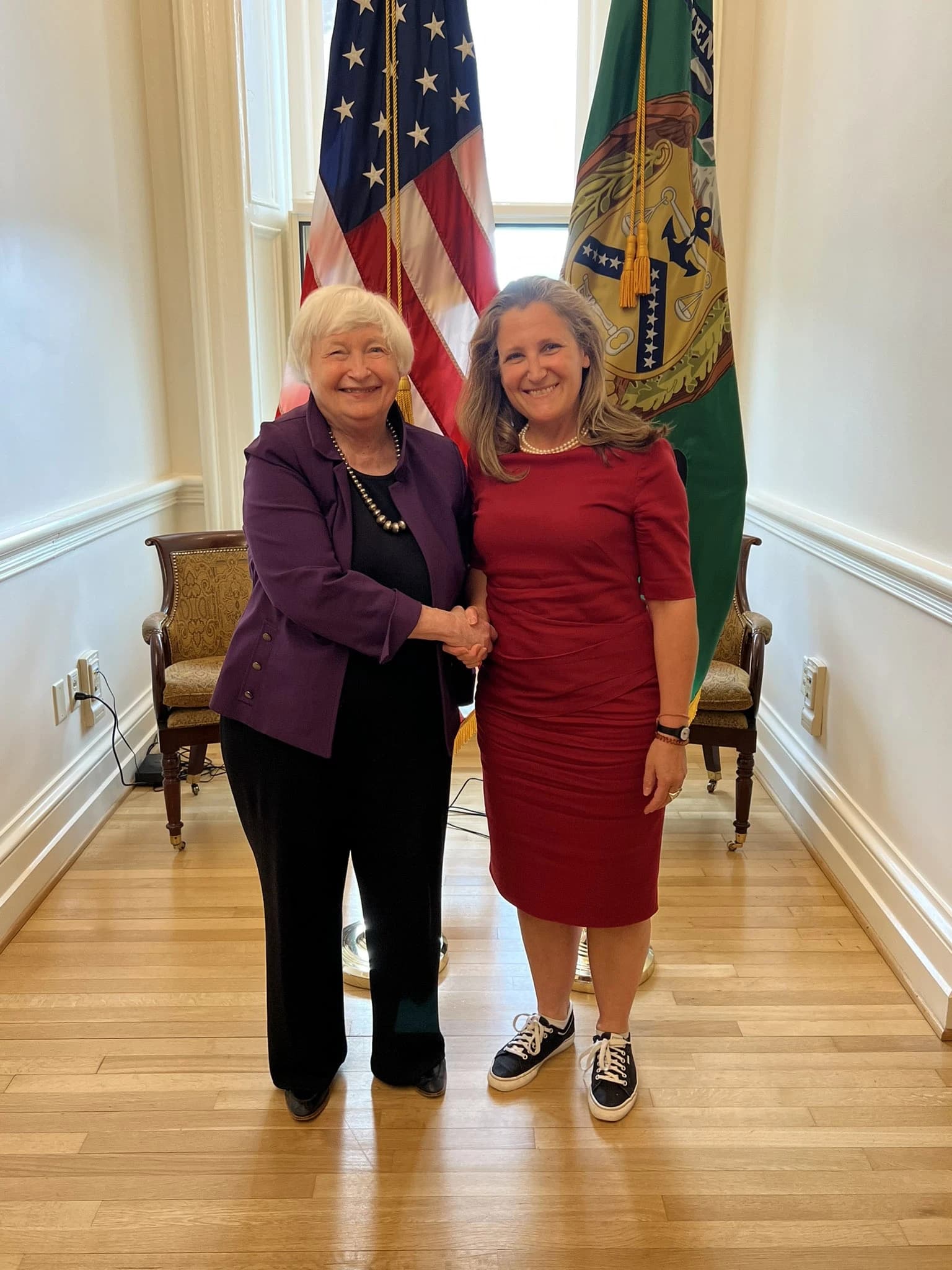 US Treasury Secretary Janet Yellen and Canadian Deputy Prime Minister Chrystia Freeland shaking hands.