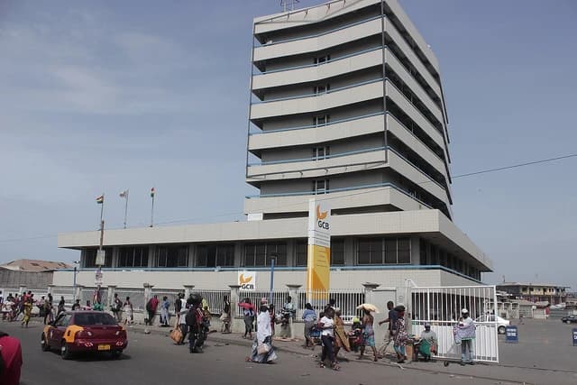 Ghana Commercial Bank building on a busy street with people walking by.