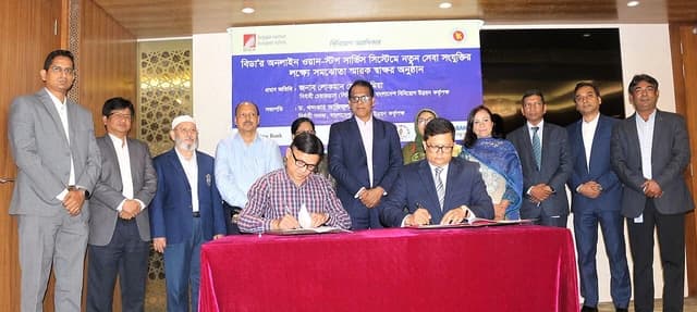 Officials from Bangladesh Investment Development Authority signing documents at an event in Dhaka.