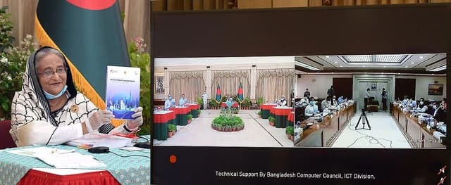 Sheikh Hasina, Prime Minister of Bangladesh, holds an investment handbook.